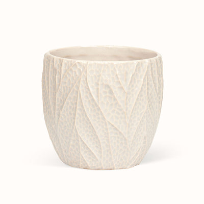 Beige Leaf-potteskjuler med afrundet form og et lyst mønster, der ligner bladnerver.